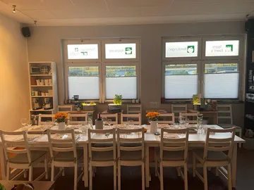 Long, decorated table arrangement in a bright room.