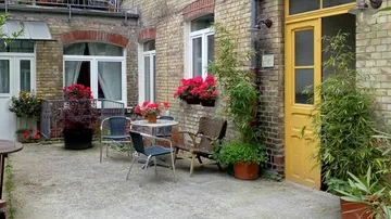Outdoor courtyard with chairs and flowers.