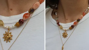 Beaded necklace with sun pendant on person.