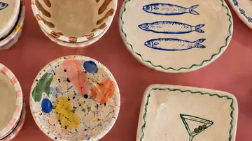 Colorful ceramic plates with artistic designs displayed.