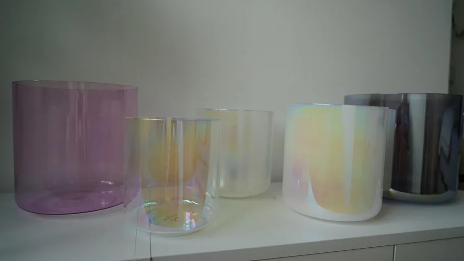 Colorful glass vases displayed on a shelf.