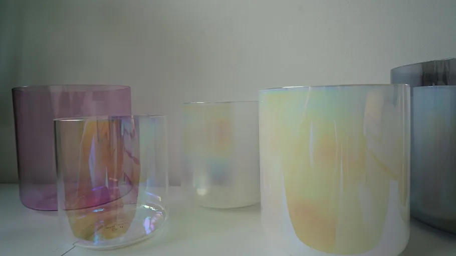 Colorful glass bowls on a white surface.