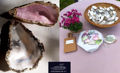 Decorative oyster shells on table with flowers.