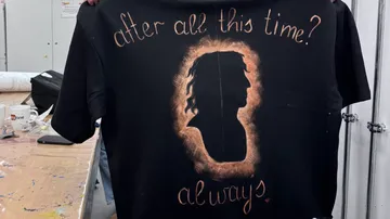 Handmade shirt with text and silhouette design.