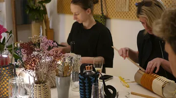 Two women crafting at a table.