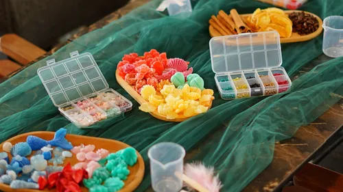 Colorful candies on a green cloth display.