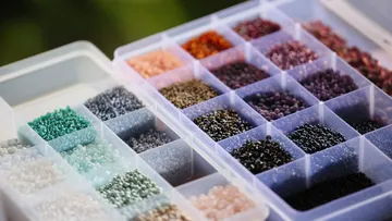 Colorful beads organized in plastic containers.