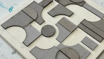 Gray geometric shapes on squared base.