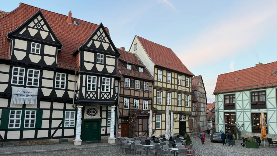Traditional half-timbered houses in cobblestone square.