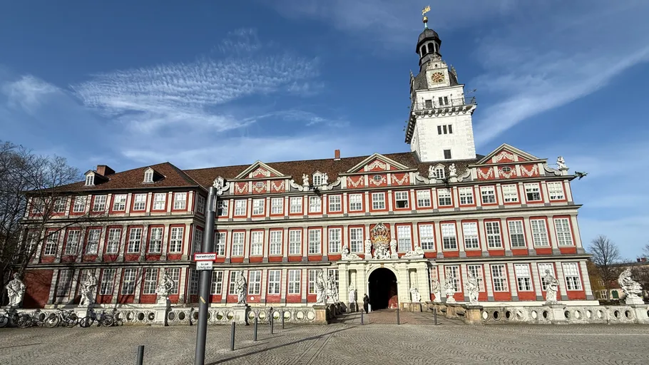 Historic castle with clock tower, sunny day.