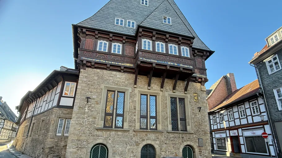 Historic timber-framed building on narrow street.
