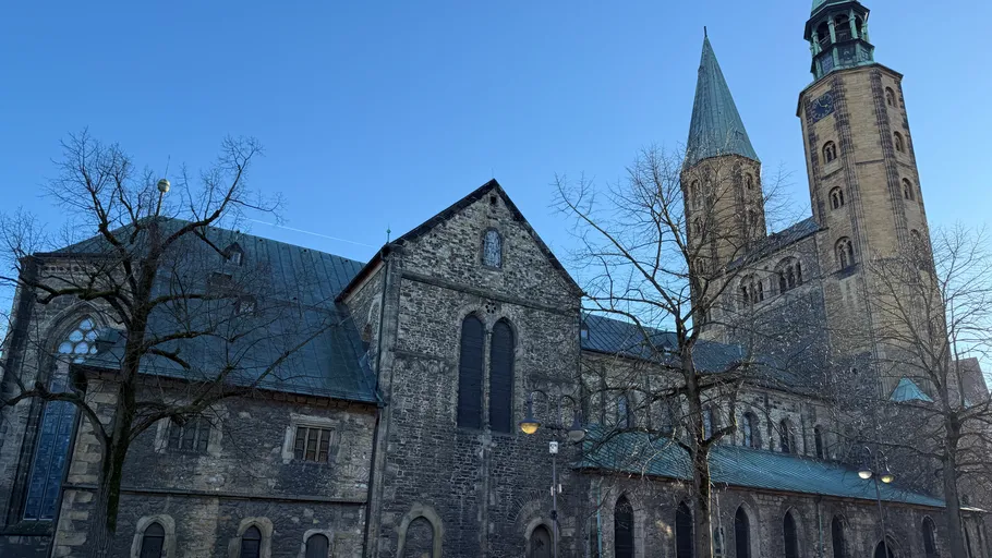 Historic church with tall spires, clear sky.