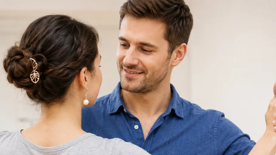 Smiling couple dancing indoors, close embrace.