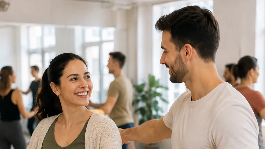 Couple dancing together, smiling in dance studio.