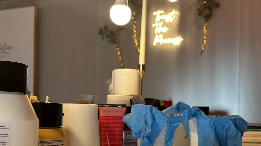 Various bottles and gloves on a table.