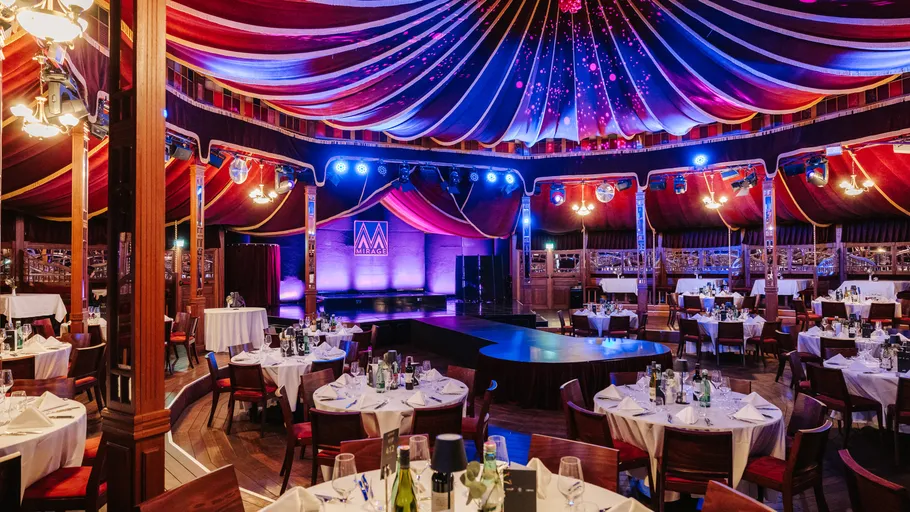 Lavish dinner setup in a colorful tent.