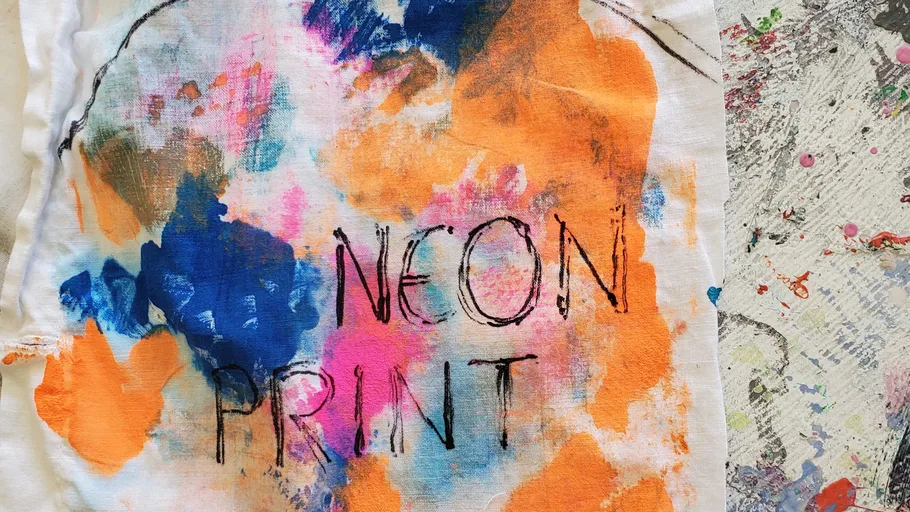 Colorful fabric with text 'NEON PRINT'.