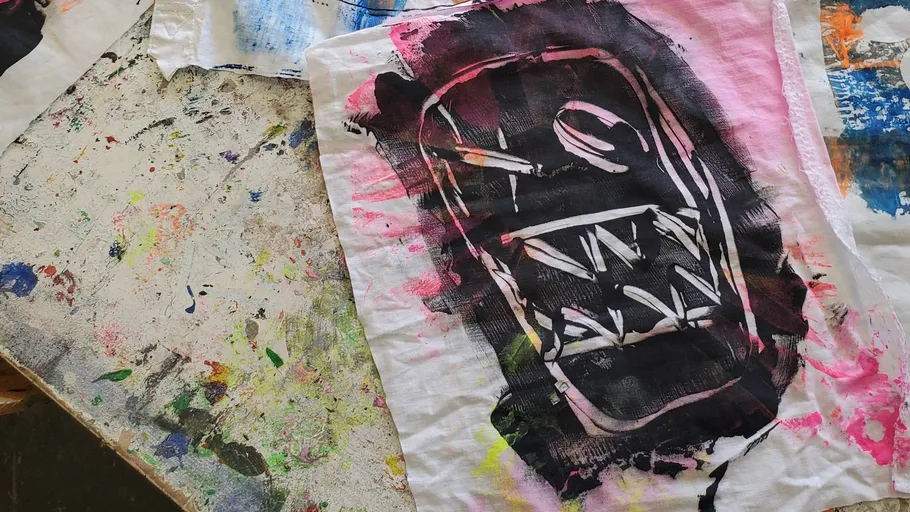 Fabric with abstract black-and-pink face design.