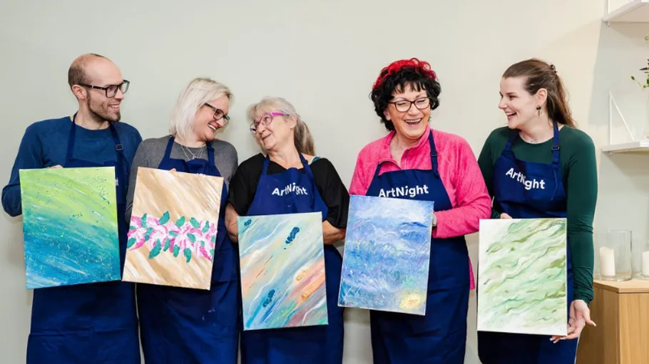 Five people displaying paintings at art class.