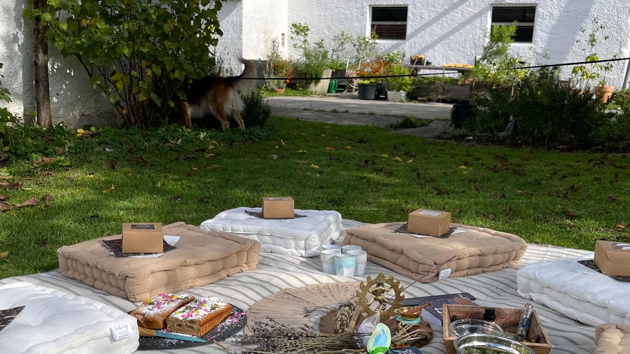 Outdoor seating with cushions and picnic arrangement.