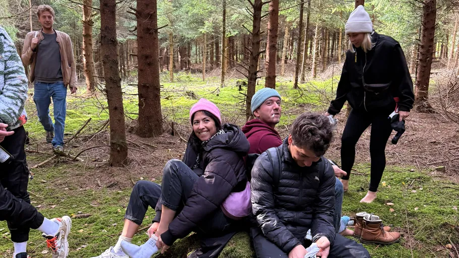Group relaxing in a forested area.