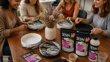 Women crafting with resin around table.