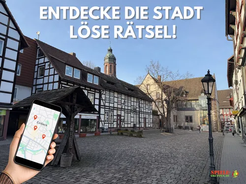 Hand holds phone showing map in historic town.