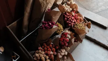 Bouquets of dried flowers in paper wrapping.