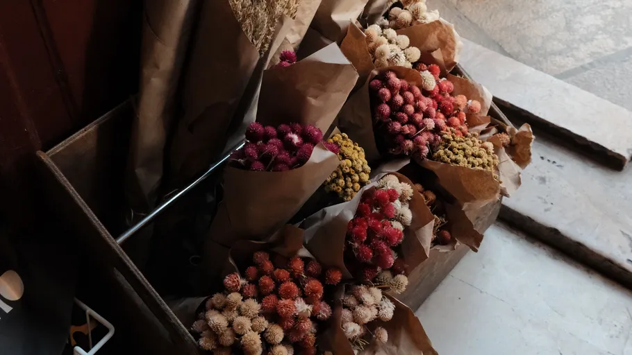 Bouquets of dried flowers in paper wrapping.