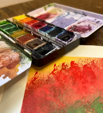 Watercolor paint set with colorful painting.