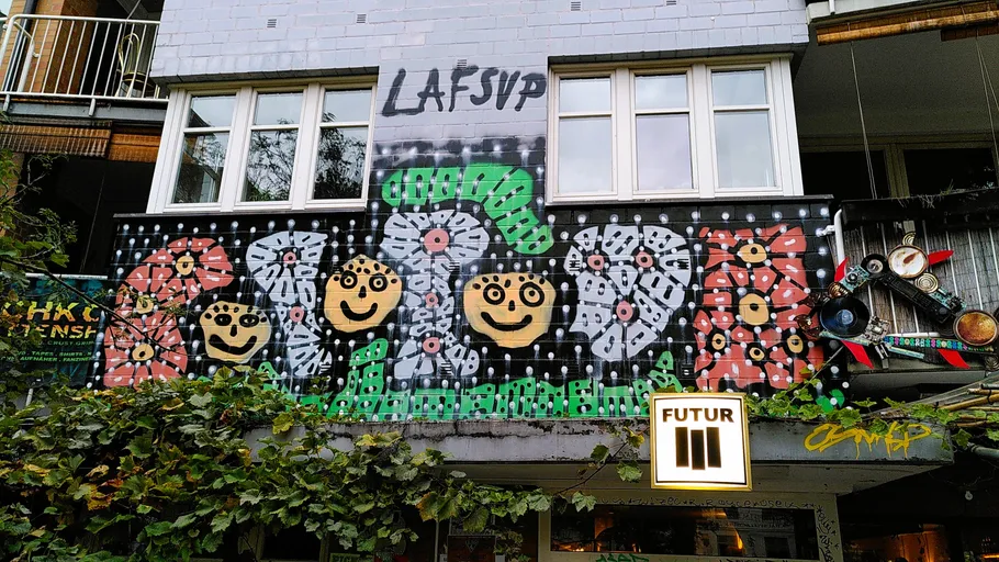 Graffiti with faces on building wall.