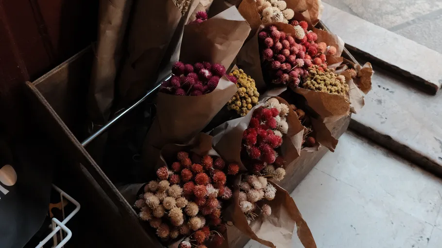 Bouquets of dried flowers in paper wraps.