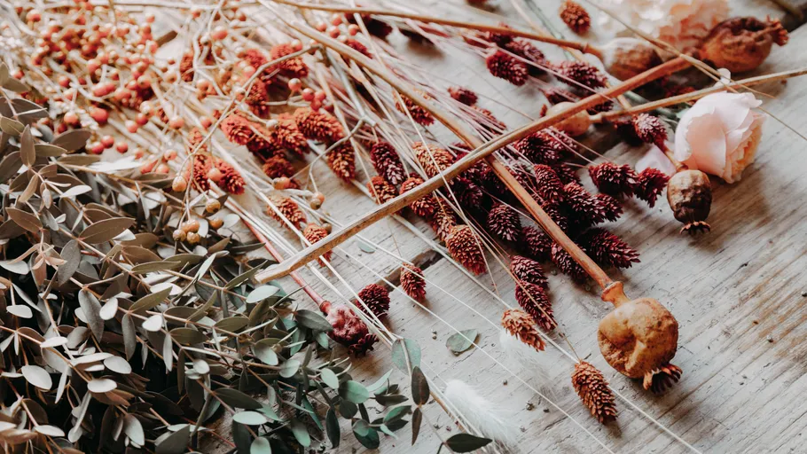 Dried flowers and leaves on wooden surface.