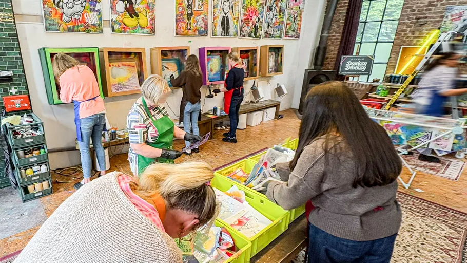 People creating art in a colorful studio.