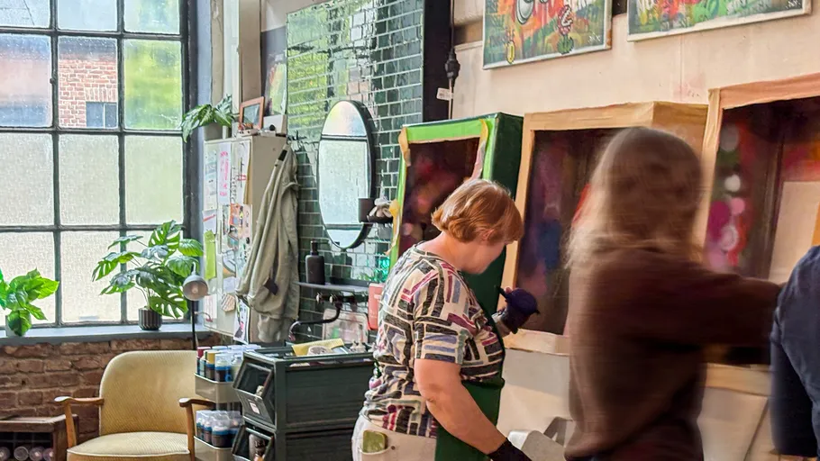 People painting in an art studio environment.