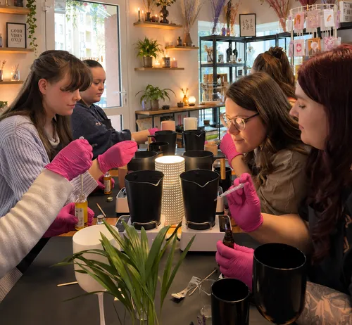 Women making candles in a cozy shop.