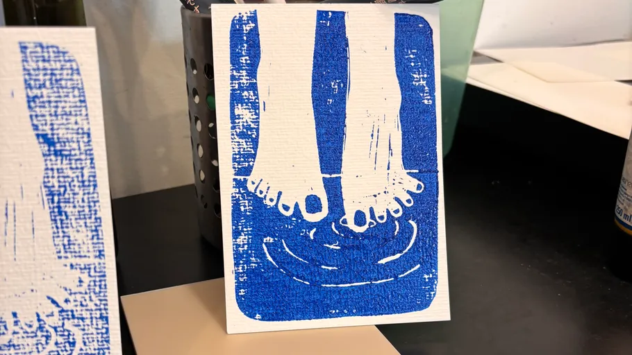 Blue and white print showing two feet in water.