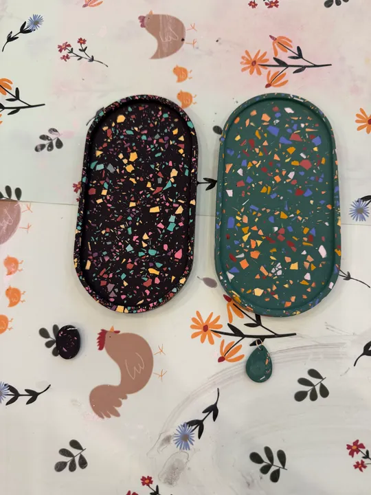 Colorful trays on floral patterned table.