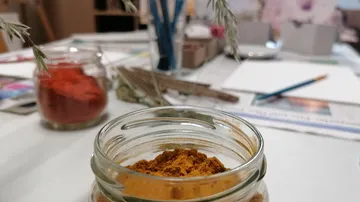 Jar of spices on craft table.
