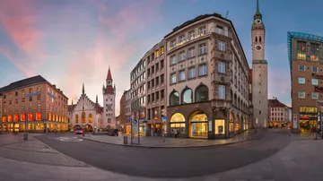 Buildings and clock tower at dusk, urban setting.