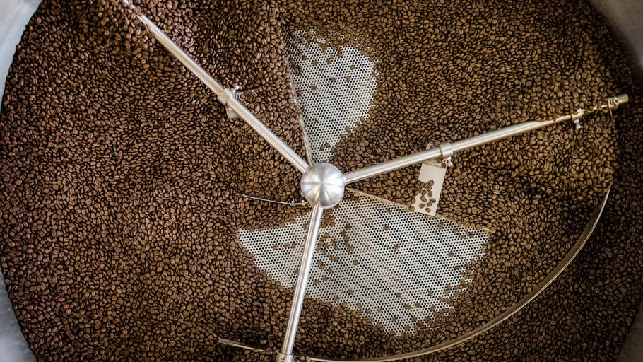 Coffee beans rotating in a roasting machine.