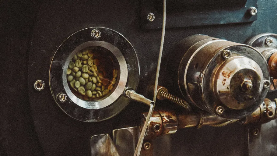Coffee beans roasting inside an industrial machine.