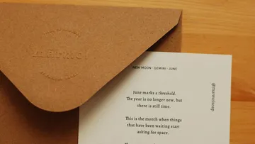 Envelope with letter on wooden table.