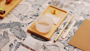 Craft items resting on a patterned table.