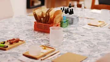 Craft materials arranged on a decorated table.