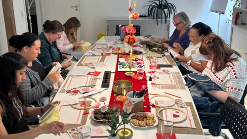 People crafting around a decorated table.