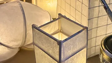 Paper lanterns glowing on a table.