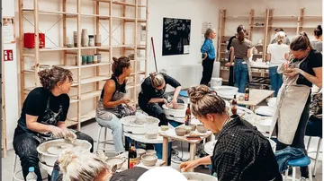 People crafting pottery in a studio workshop.