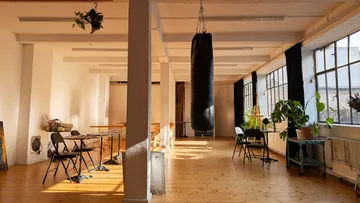 Punching bag hanging in bright art studio.