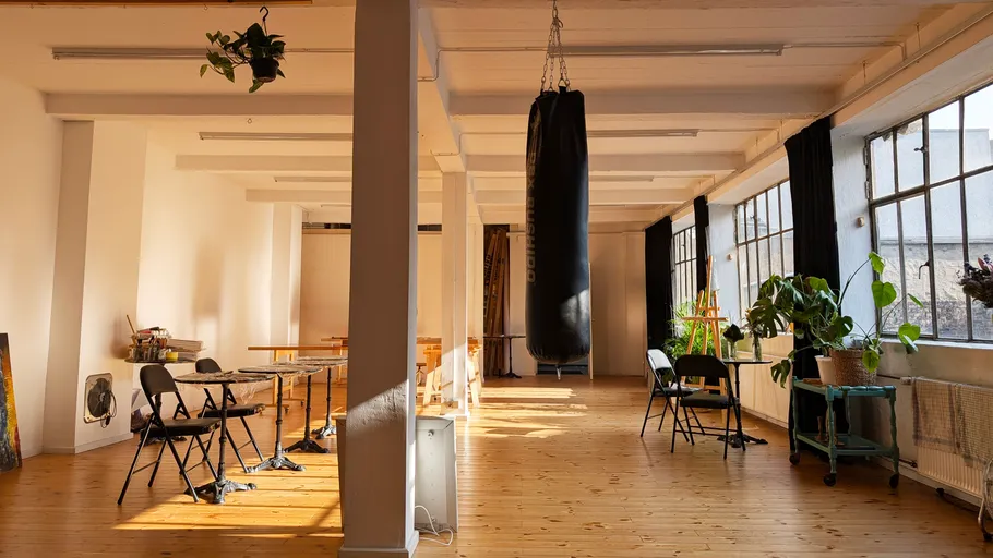 Punching bag hanging in bright art studio.
